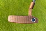 The Bettinardi Queen B 8 putter has a milled honeycomb pattern face