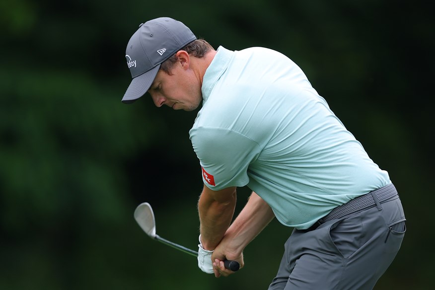 Matt FItzpatrick chips cross-handed.